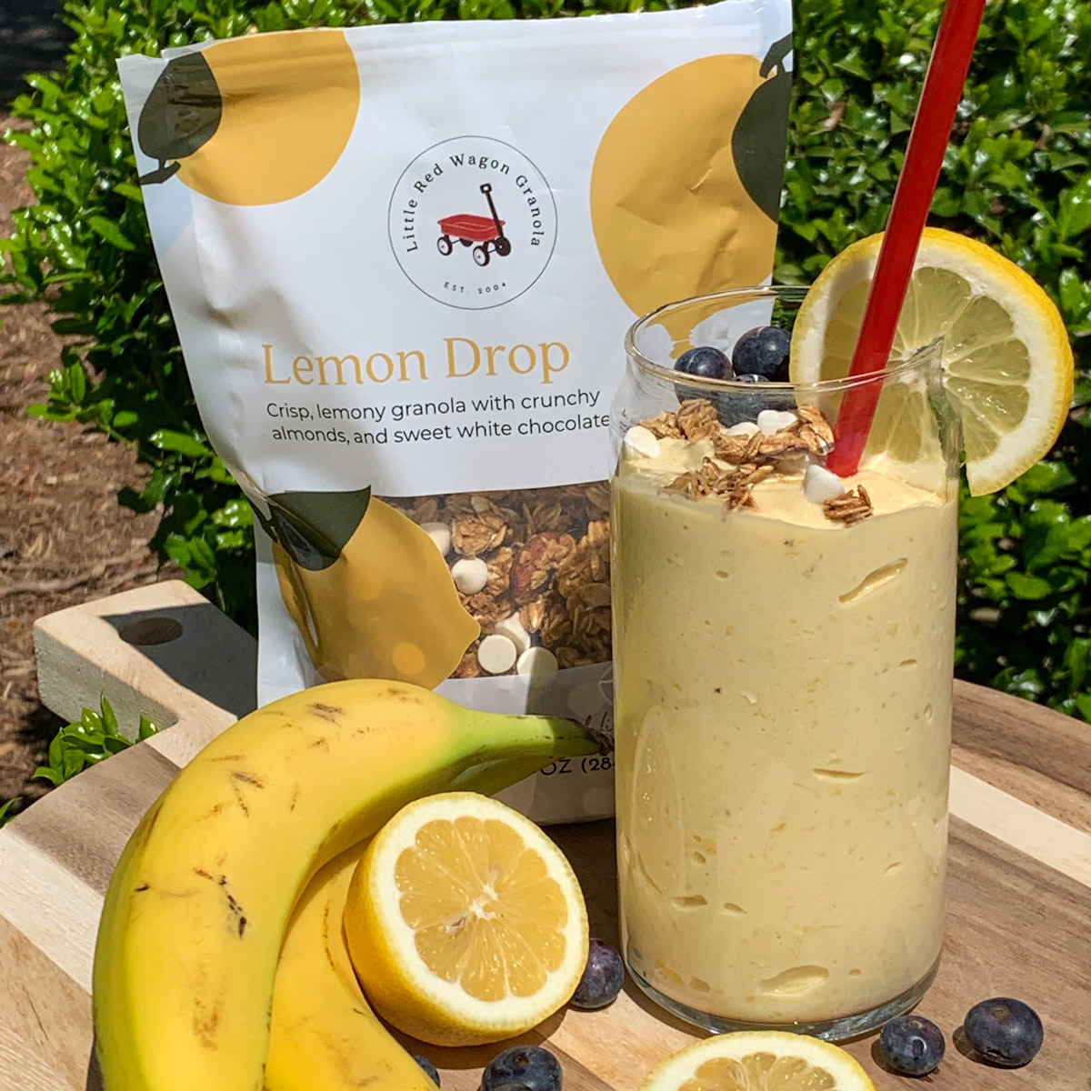 a sunshine smoothie sitting on a wooden board