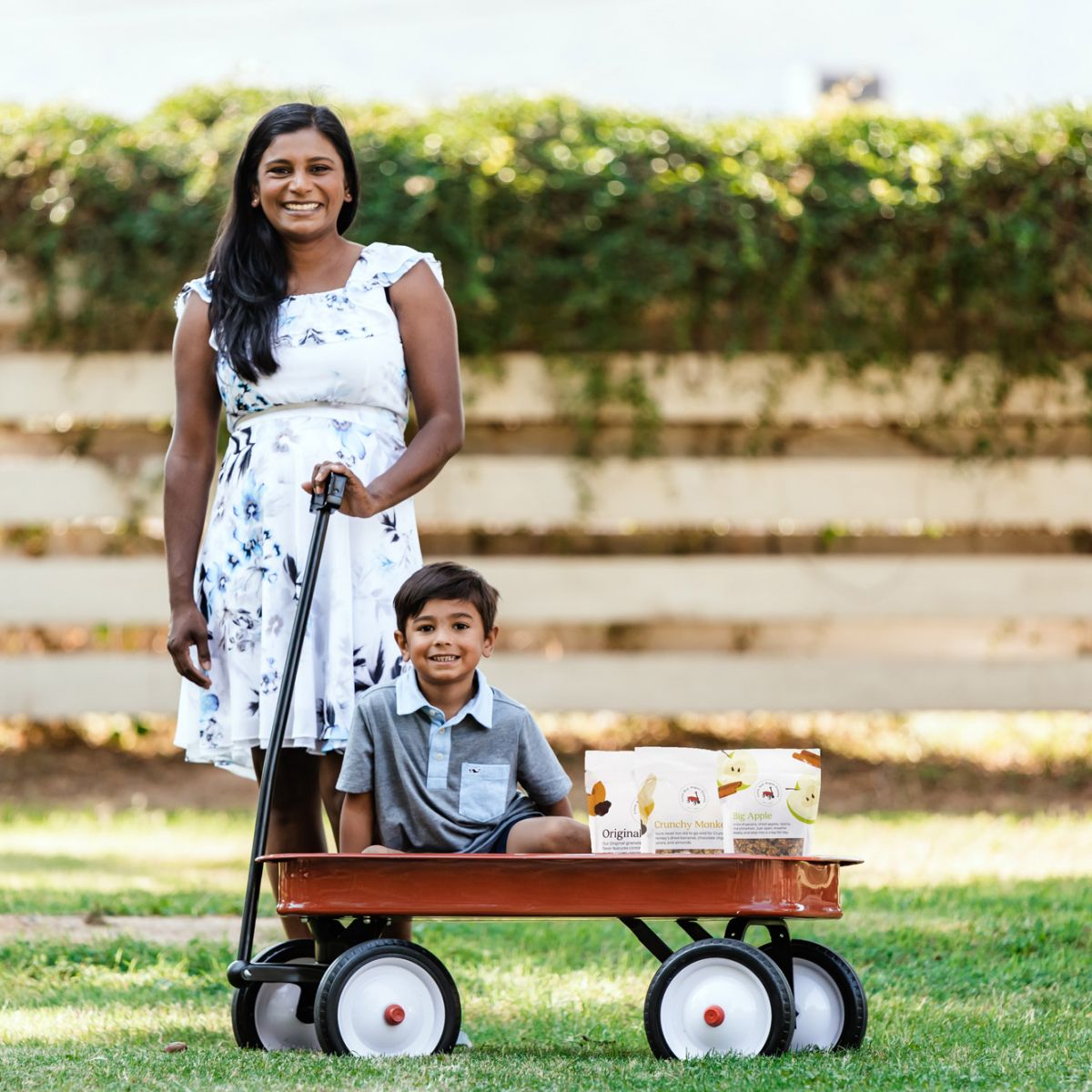 Ven with her son in a wagon loaded with a travel snack box