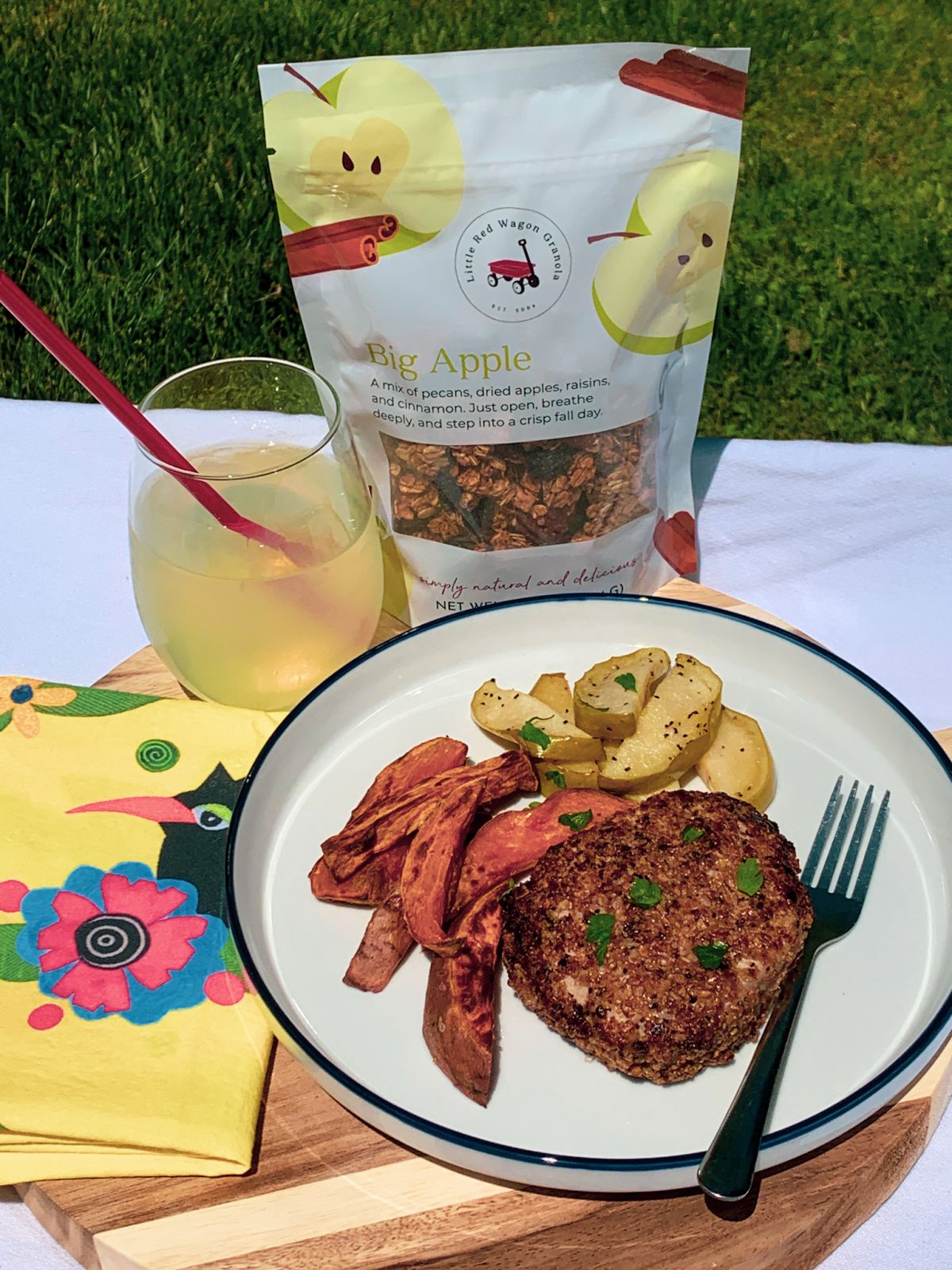 crusted pork chops dish on a plate next to LRWG'S Big Apple Granola