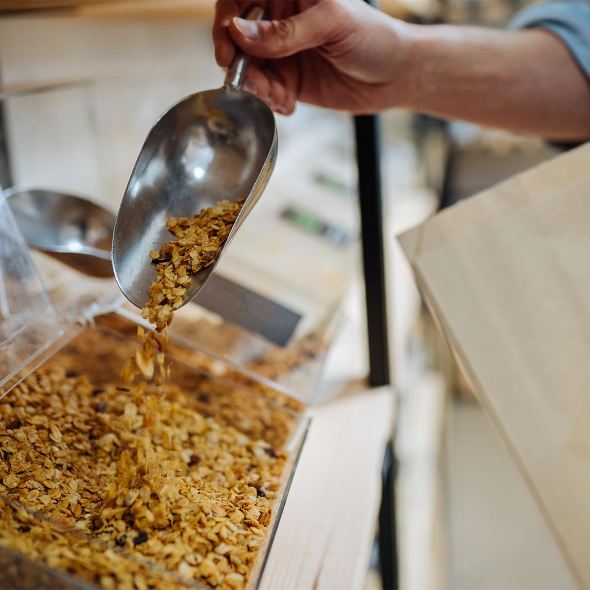 where to buy granola, someone scooping out granola