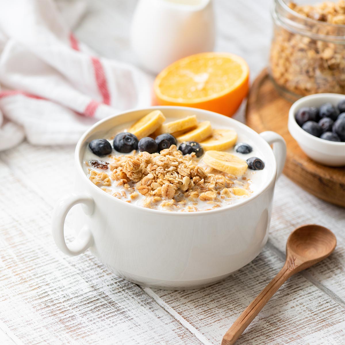 Yogurt bowl with granola bananas and blueberries for a blog discussing breakfast bowl ideas